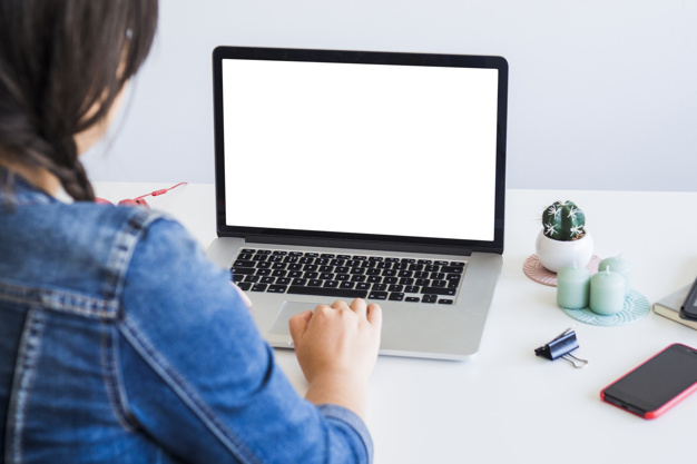 woman-using-laptop-near-smartphone-table_23-2148040485